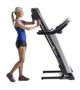 Woman folding a Gold's Gym Trainer 720 treadmill