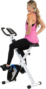 Back view of a young woman on an exercise bike