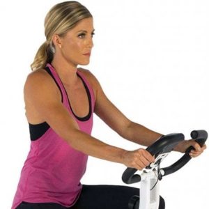 Close up of a young woman on an exercise bike