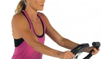 Close up of a young woman on an exercise bike