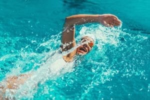 Woman swimming freestyle in a pool