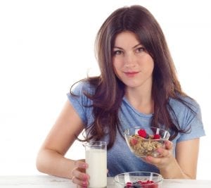 Finding the motivation to lose weight - Young woman eating a healthy breakfast