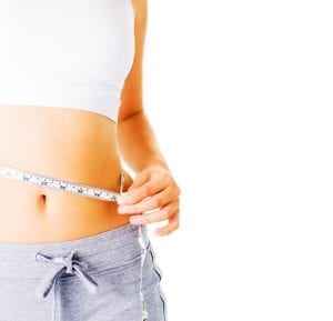 Young Woman Measuring Her Waist