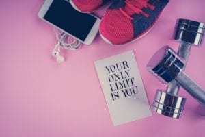 sneakers, phone and dumbbells on a pink background