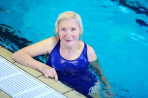 Senior woman swimming for exercise