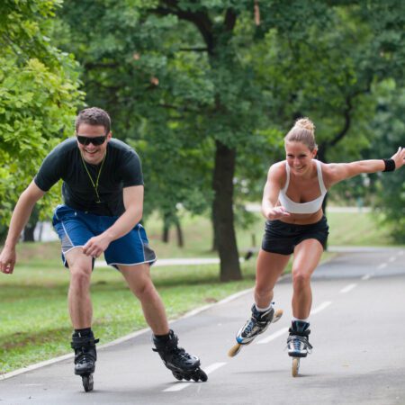 Young couple roller skating in the park.