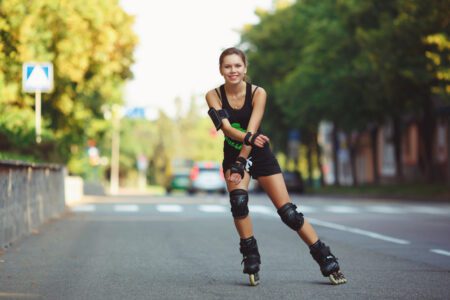 woman roller skating wearing wrist and knee pads