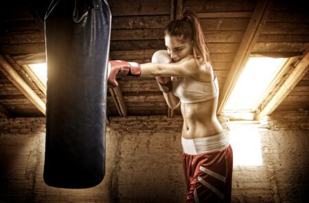 woman working out with punching bag